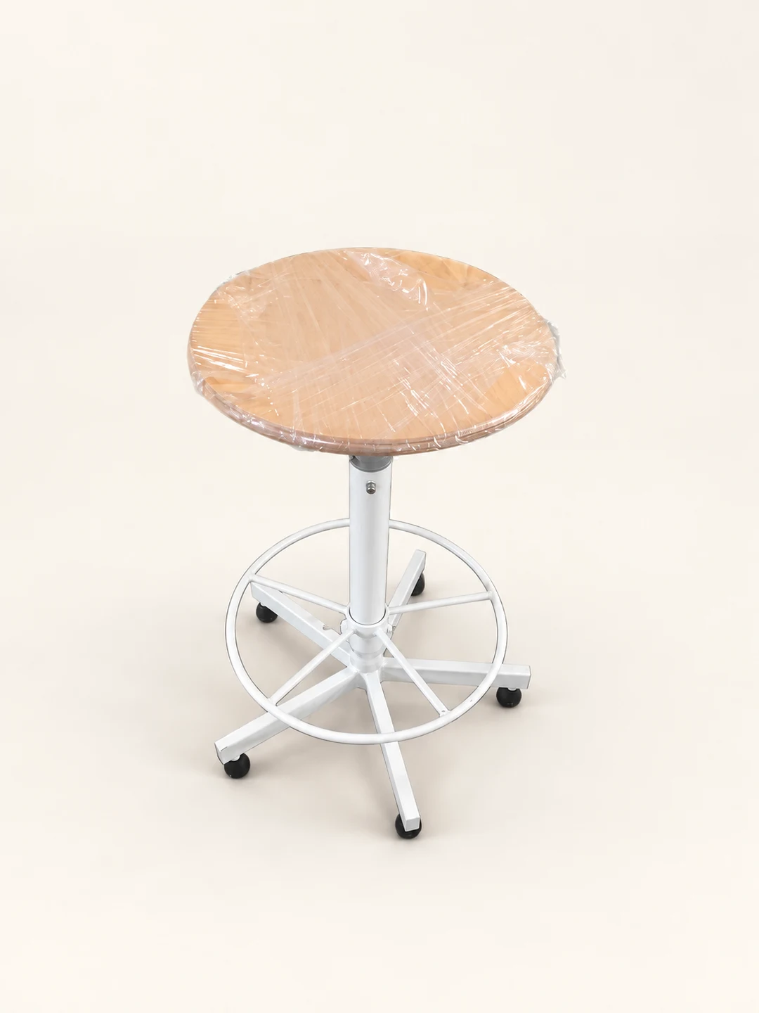 Round padded stool on white ring base — AI-cleaned product photograph