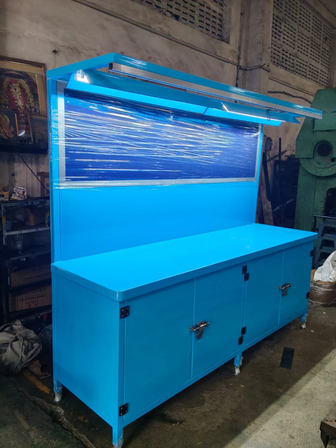 Bright-blue cabinet bench with wrapped upper panel — original photograph