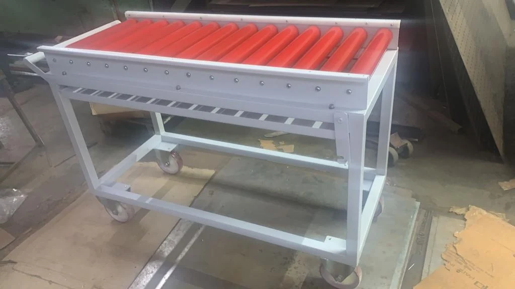 Short mobile red roller conveyor — original photograph