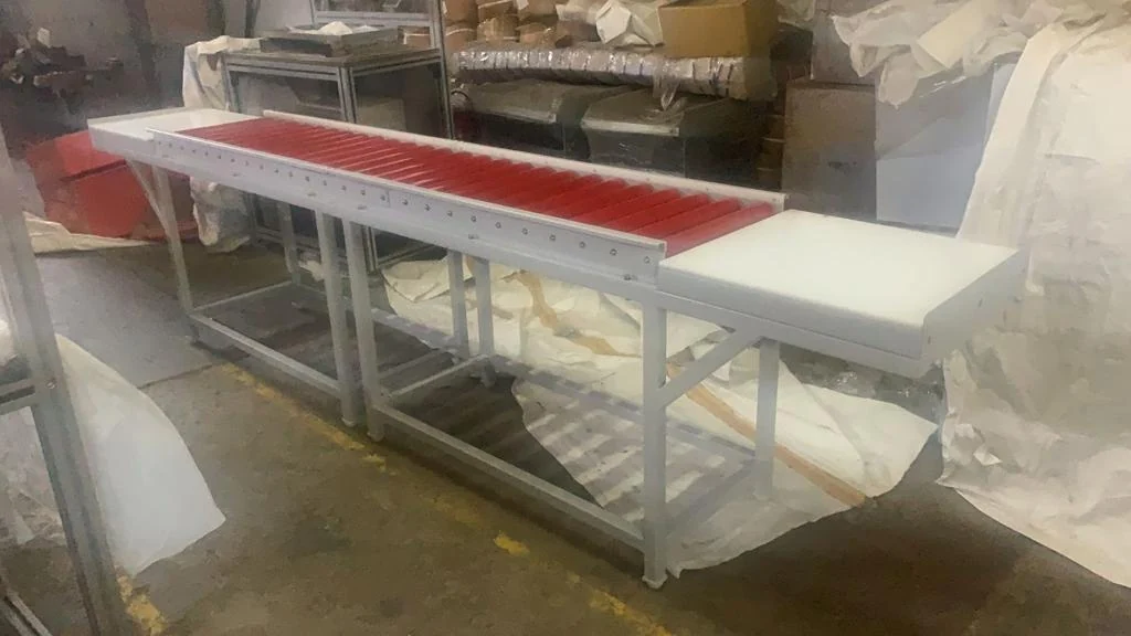 Long red roller table with white side surface — original photograph